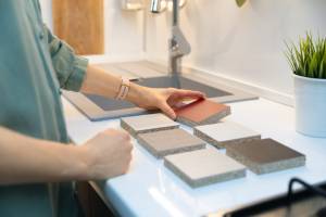 Image of person choosing between Corian and quartz countertop materials - Crowley's Granite in Portland OR