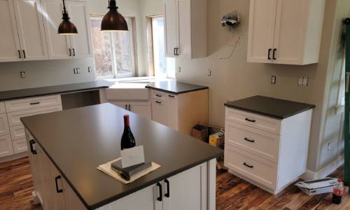 Dark colored honed quartz countertops installed by Crowley's
